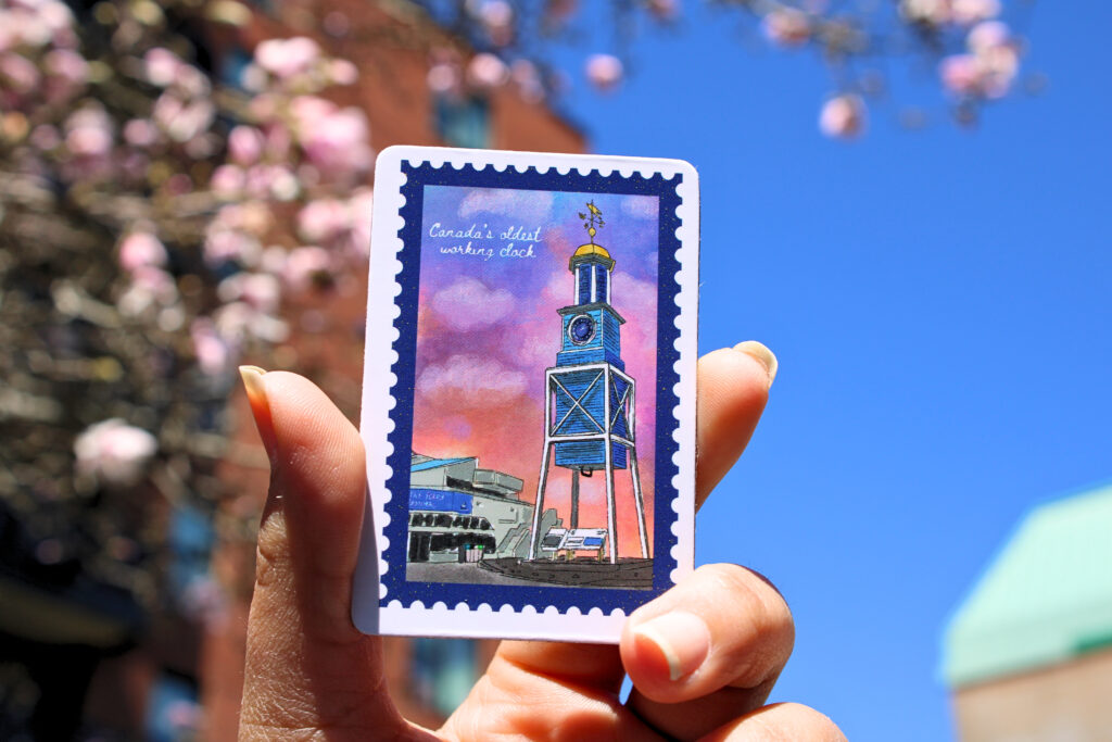 A 2" x 3" rectangle sticker featuring HMC dockyard clock.
